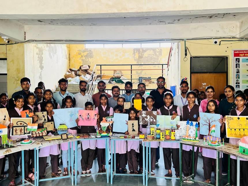 Students presenting craft models and paintings at a school exhibition