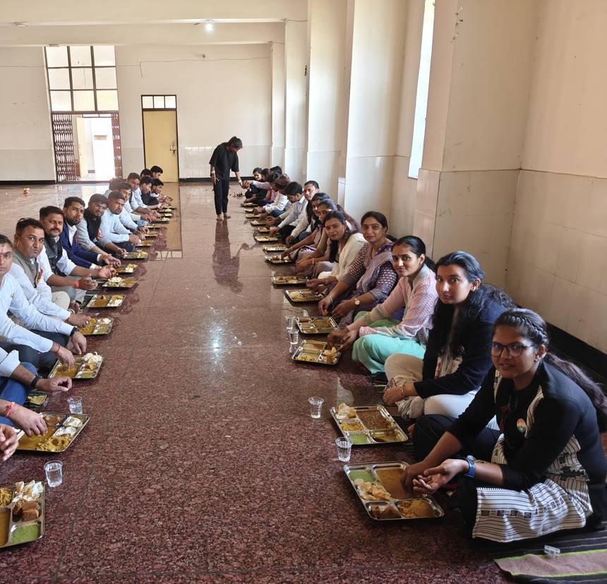 The school dining hall with long rows seated for a meal