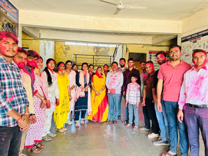 Staff of the school celebrating Holi together in the corridor