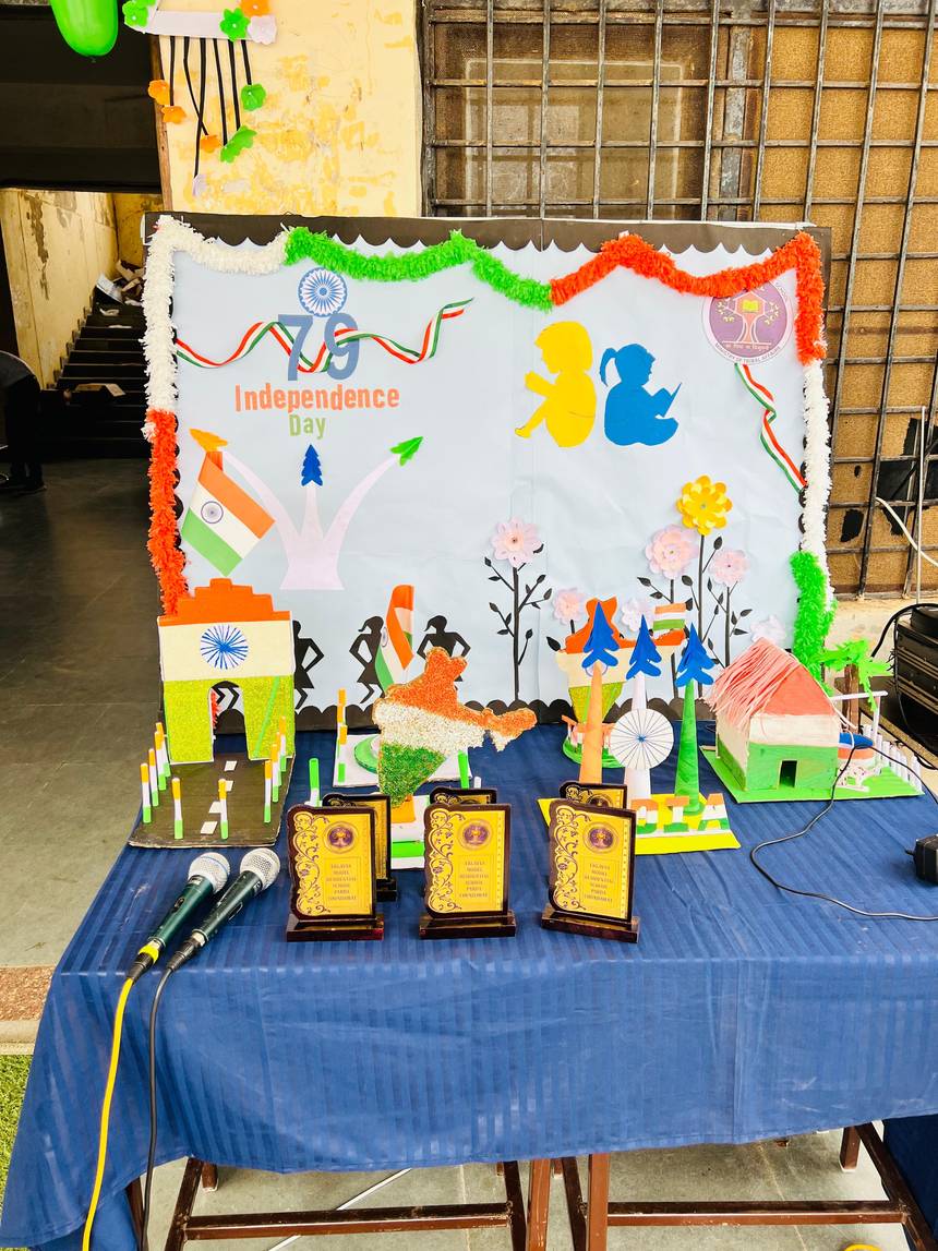Independence Day display table with student craft models and trophies