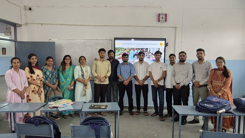 Staff at a life skills development session in front of the smart class screen