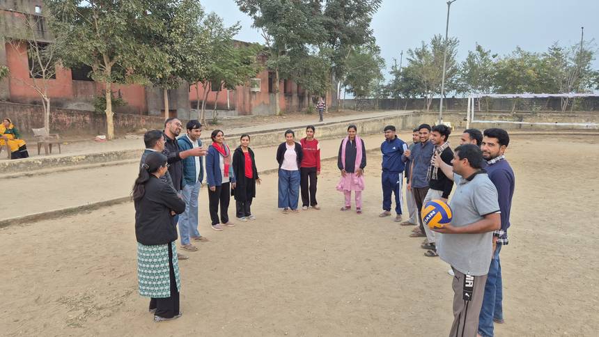 Teachers gathered on the school ground for a volleyball session