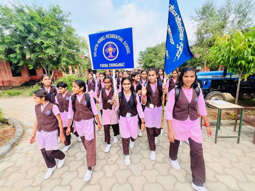 Students of Eklavya Model Residential School, Parda Chundawat walking with the school banner