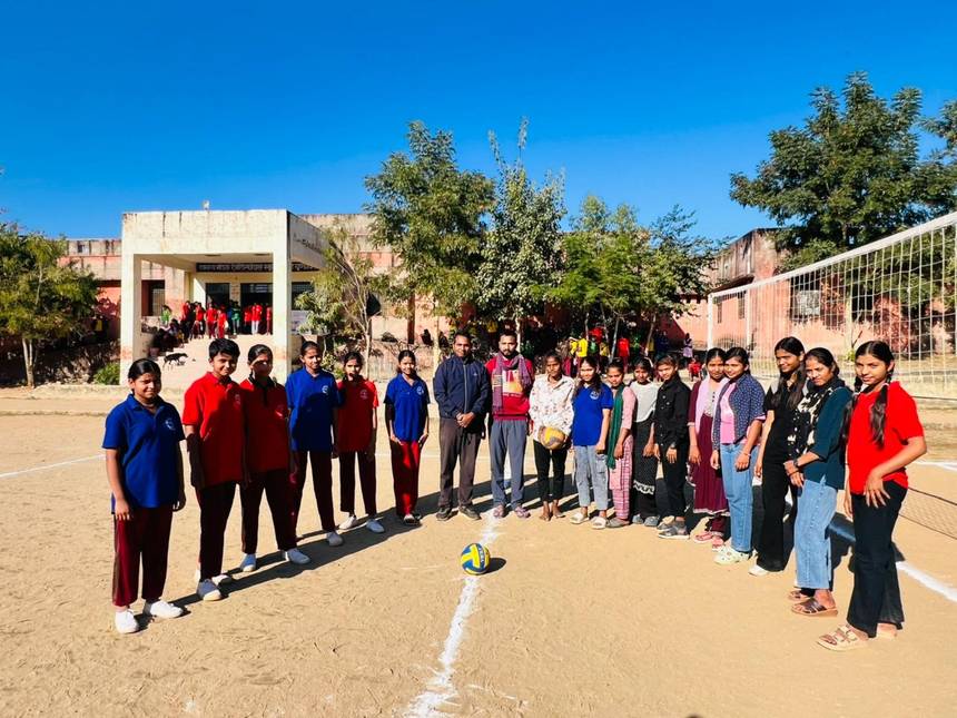 Students and teachers on the volleyball ground inside the school campus